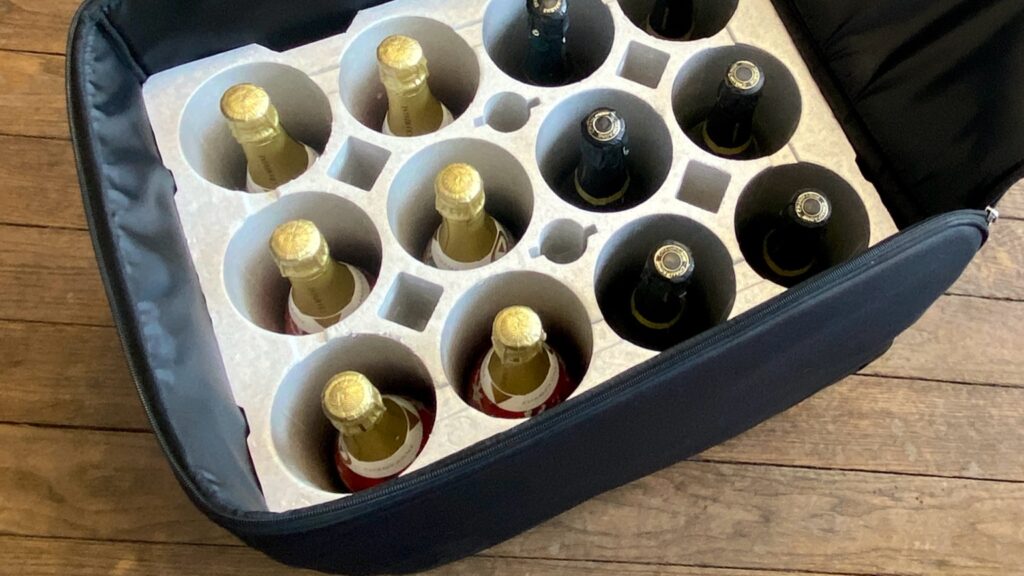 Champagne bottles securely packed in a foam-lined wine travel suitcase