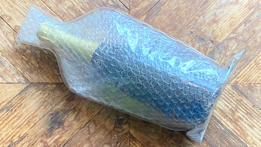 Champagne bottle placed inside a leak-proof Wineskin（Bottle Protectors） for safe travel