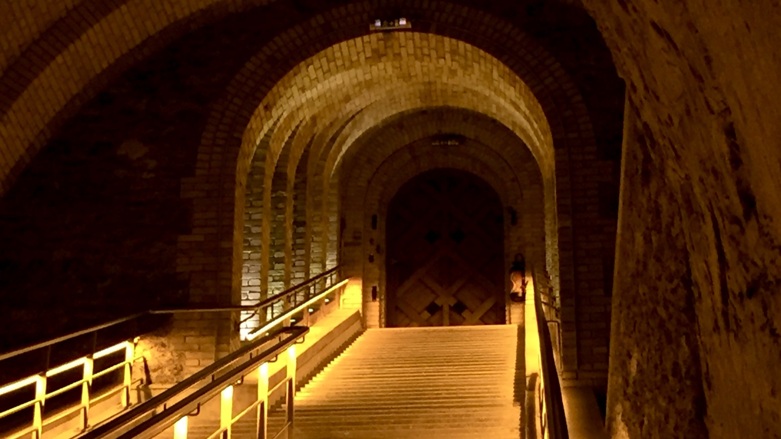 Champagne house cellar staircase leading to an underground tasting area in Reims
