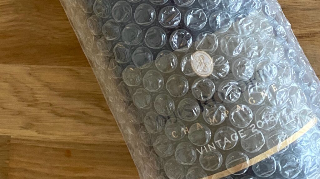 Champagne bottle wrapped in thick bubble wrap for suitcase travel