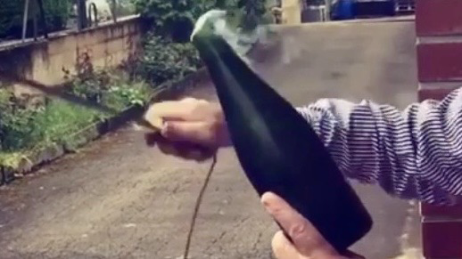 Opening a Champagne bottle with a saber during a sabrage experience in Champagne