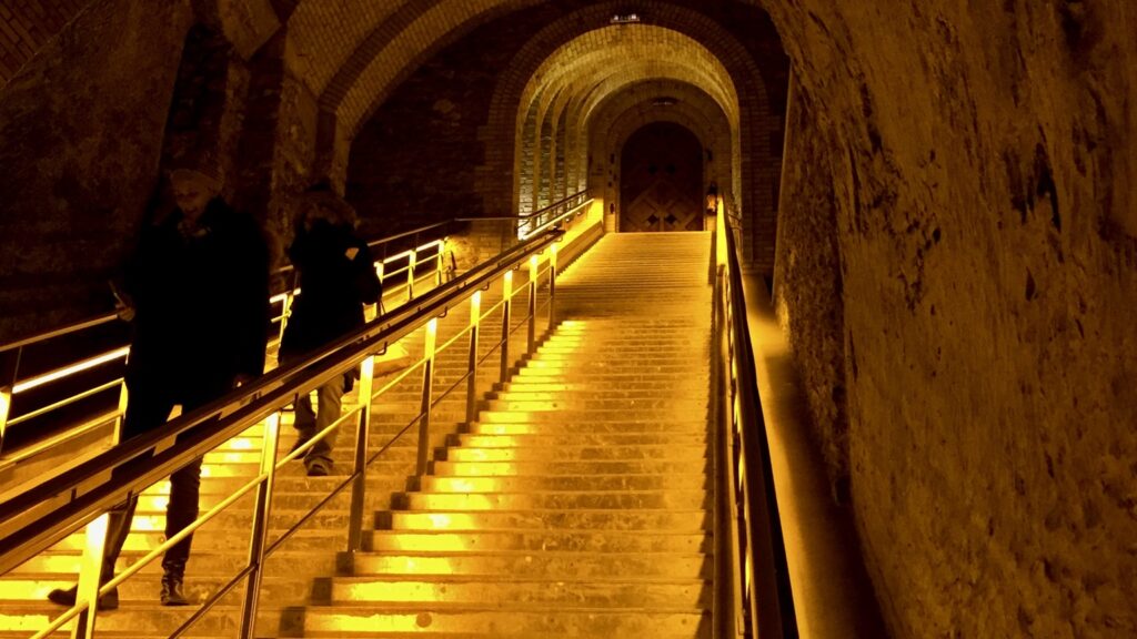 Illuminated staircase descending into the Veuve Clicquot underground cellars in Reims
